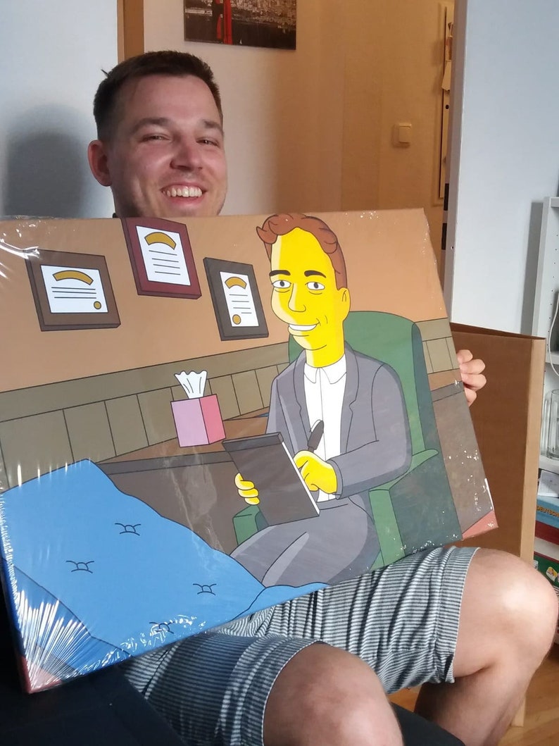 May include: A person holding a canvas print of a cartoon character sitting in a therapist's office. The cartoon character is yellow with black hair and is wearing a grey suit. The canvas print is wrapped in plastic.