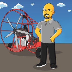 May include: A man standing next to a red paramotor with a large propeller. The paramotor has a black seat and a black engine.