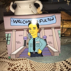 May include: A cartoon illustration of a person with yellow skin and blue hair standing in front of a building with the words "Welcome to Fulton" on a sign above the entrance. The person is wearing a blue shirt with a name tag that says "Brandon Awalt" and a black tie. The building has two police signs on the sides.
