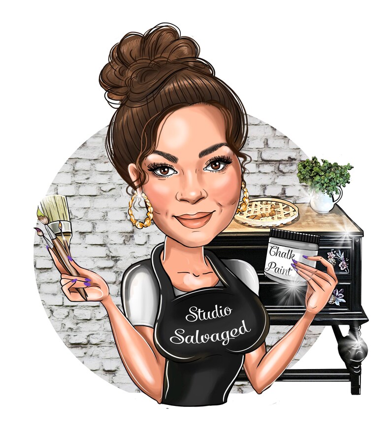 May include: A woman with brown hair in a bun is holding paintbrushes and a jar of chalk paint. She is wearing a black apron with the text "Studio Salvaged" on it. She is standing in front of a black dresser with a white brick wall in the background.