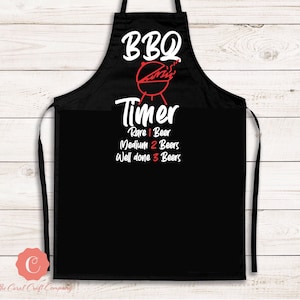 May include: Black BBQ apron with white and red text. The text reads "BBQ Timer" with a graphic of a grill. Below the timer are the words "Rare 1 Beer, Medium 2 Beers, Well done 3 Beers."