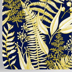 May include: A seamless pattern featuring gold and white botanical illustrations of ferns, leaves, and flowers on a dark blue background.