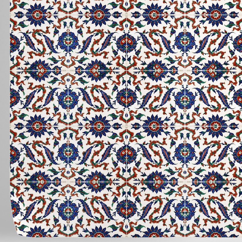 May include: A white tile with a repeating pattern of blue, red, and green floral designs. The tile has a traditional Turkish style.