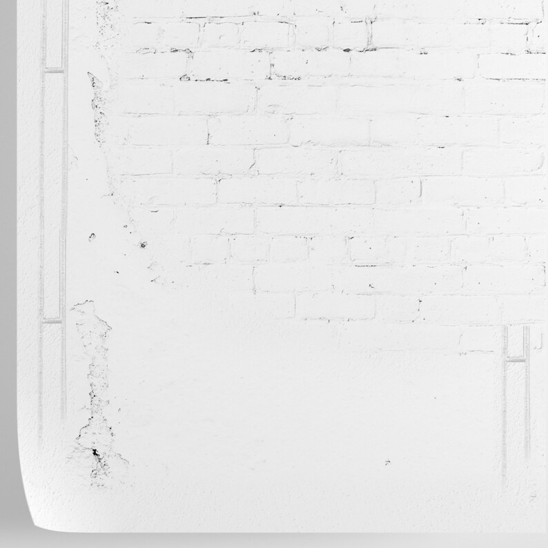 May include: A white brick wall with some of the bricks showing through the paint. The wall is slightly textured and has a few small cracks.