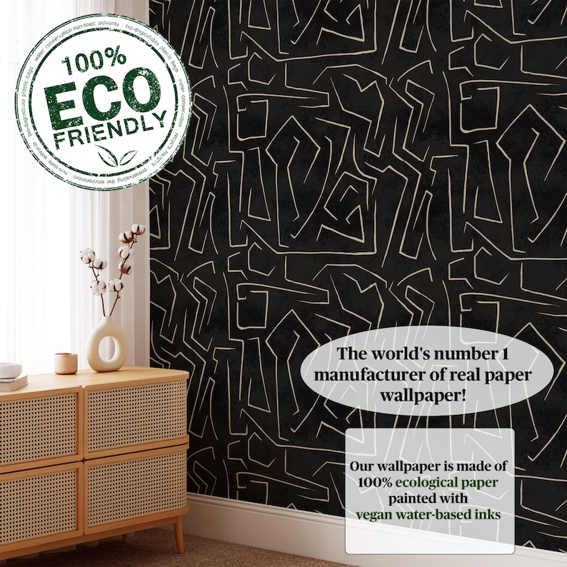 May include: Black and gold wallpaper with a geometric pattern. The text "100% ECO FRIENDLY" is in a green circle in the upper left corner. The text "The world's number 1 manufacturer of real paper wallpaper!" is in a white oval in the lower right corner. The text "Our wallpaper is made of 100% ecological paper painted with vegan water-based inks" is in a white rectangle in the lower right corner.