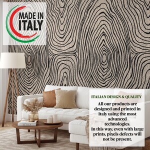 May include: A living room scene featuring a white sofa with brown and beige pillows, a wooden coffee table, and a floor lamp. The wall is covered with wallpaper with a black and beige tree ring design. The text "MADE IN ITALY" is visible.