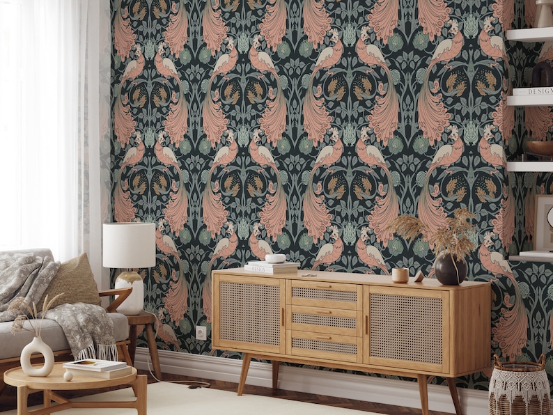 May include: A living room interior with a dark teal wallpaper featuring a repeating pattern of pink peacocks with gold accents. A wooden dresser with woven rattan doors sits in front of the wallpaper.