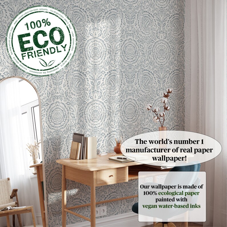 May include: A close-up of a white wallpaper with a blue floral pattern. The text "100% ECO FRIENDLY" is in a green circle on the left side of the image. The text "The world's number 1 manufacturer of real paper wallpaper!" is in a white circle on the right side of the image. The text "Our wallpaper is made of 100% ecological paper painted with vegan water-based inks" is in a white circle below the text about the manufacturer.