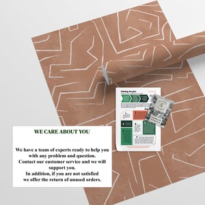 May include: A brown and white patterned wallpaper roll with a white geometric design. The text "WE CARE ABOUT YOU" is printed on a white rectangle. The text reads: "We have a team of experts ready to help you with any problem and question. Contact our customer service and we will support you. In addition, if you are not satisfied we offer the return of unused orders."