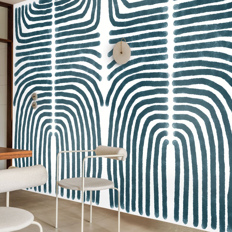 May include: A white wall with a blue and white abstract pattern wallpaper. The wallpaper features a repeating pattern of curved lines.