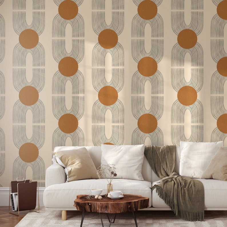 May include: A white couch with brown throw blankets in front of a wall with a geometric pattern of brown circles and gray lines.