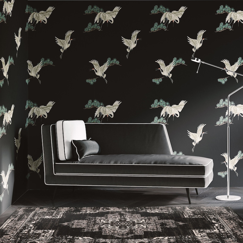 May include: A black chaise lounge with white piping sits on a black and white patterned rug in front of a black wall with a white crane pattern.