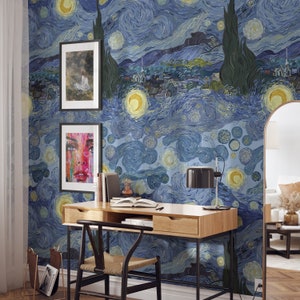 May include: A home office with a desk and chair in front of a wall covered in a blue and yellow starry night wallpaper. The wallpaper is a reproduction of Vincent van Gogh's famous painting.