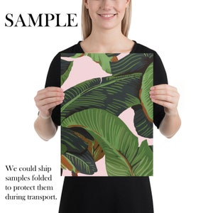 May include: A pink and green tropical leaf print poster. The leaves are large and overlapping, creating a lush and vibrant design.