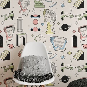 May include: A white chair with a gray knitted pillow in front of a wall with a repeating pattern of colorful illustrations. The illustrations include busts of people, arches, stars, planets, and hands.