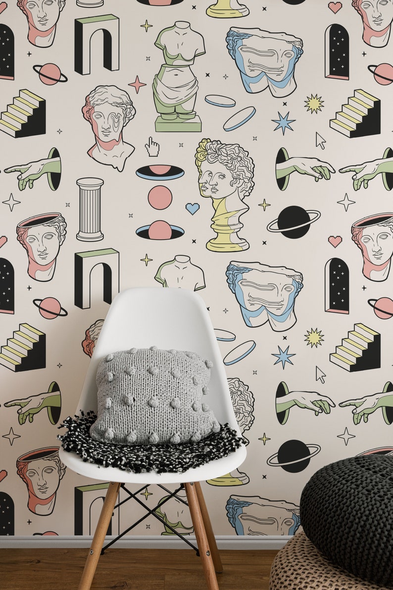 May include: A white chair with a gray knitted pillow in front of a wall with a repeating pattern of colorful illustrations. The illustrations include busts of people, arches, stars, planets, and hands.