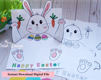 Puede incluir: Manualidad de conejo de Pascua imprimible con un diseño emergente. La manualidad incluye un conejo, zanahorias, huevos y huellas de patas. El texto "Feliz Pascua" está incluido en la manualidad.