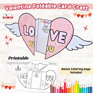 Puede incluir: Una manualidad de tarjeta plegable imprimible para el Día de San Valentín. La tarjeta en forma de corazón con alas tiene las palabras "LOVE YOU". Incluye una página para colorear adicional y el texto "Happy Valentine's Day".