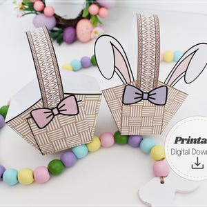 Printable Easter bunny basket template showing two assembled paper baskets with ears and bows