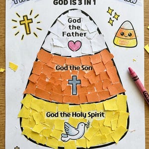 May include: A paper craft project titled The Trinity Candy Corn God is 3 in 1. It features a large candy corn shape filled with white, orange, and yellow torn paper pieces, labeled God the Father, God the Son, and God the Holy Spirit.