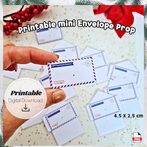 May include: A collection of printable mini envelope props. Each envelope is white with red and blue striped borders, and features the text "Northpole Express" and a stamp design. The dimensions are 4.5 x 2.5 cm.
