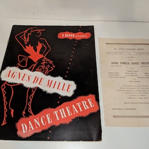 May include: Black and white program for Agnes de Mille Dance Theatre. The program features a red silhouette of a dancer in a red dress and black tights. The text "Agnes de Mille Dance Theatre" is in red and white letters.
