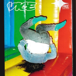 May include: A magazine cover with the word "VICE" in white letters on a green, blue, yellow, and red background. A person is upside down on a bouncy house with their legs in the air.