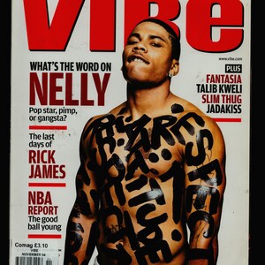 May include: A magazine cover featuring a shirtless man with black ink markings on his chest and torso. The magazine is titled "VIBE" and features the words "What's the word on Nelly" and "The last days of Rick James".