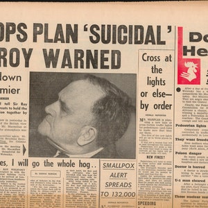 May include: A black and white newspaper clipping from the Daily Herald, dated March 1, 1962, with the headline "TROOPS PLAN 'SUICIDAL' SIR ROY WARNED". The article discusses a showdown between the government and Sir Roy Welensky, the Prime Minister of the Central African Federation. The article also includes a photo of Sir Roy Welensky.