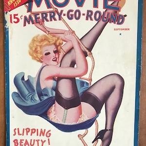 May include: A vintage magazine cover featuring a woman in a blue dress and stockings, hanging from a rope ladder. The cover reads "Movie Merry-Go-Round" and "Slipping Beauty!" in red text.