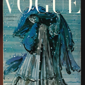 May include: A vintage Vogue magazine cover featuring a blue and white illustration of a woman in a long dress and a shawl, walking through a snowy scene. The cover text reads "Christmas Gifts" and "December 1949 - Price 35c".