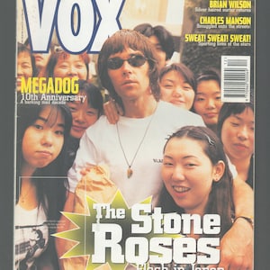May include: The Stone Roses, a British rock band, are pictured on the cover of the December 1995 issue of Vox magazine. The band is surrounded by Japanese fans. The cover also features the text "Flash in Japan".