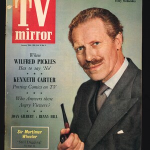 May include: A vintage magazine cover for "TV Mirror" from January 29th, 1955. The cover features a portrait of a man in a suit holding a pipe. Text includes "WILFRED PICKLES", "KENNETH CARTER", and "BENNY HILL".