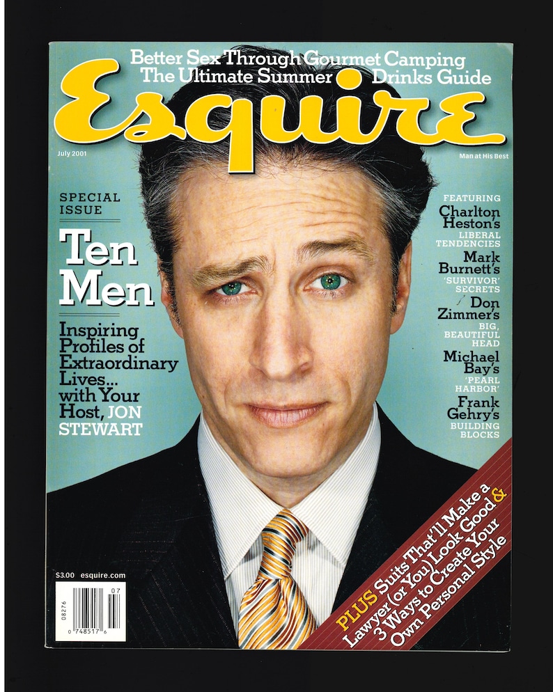 May include: A magazine cover featuring a man in a suit and tie. The magazine is titled "Esquire" and the cover story is "Ten Men: Inspiring Profiles of Extraordinary Lives... with Your Host, Jon Stewart".