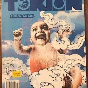 May include: A magazine cover with a blue background and the word "TOKION" in white letters. The cover features a baby in a red diaper, surrounded by white clouds. The text "BORN AGAIN" is printed in white letters below the title. The magazine's subtitle, "THE SOUND OF NOW", is printed in white letters in the upper right corner.