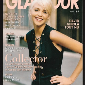 May include: A magazine cover featuring a woman with blonde hair wearing a black sleeveless dress with a lace-up front. The magazine is titled "Glamour" and features the text "David Ginola Tout Nu" and "Collector".