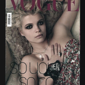 May include: A magazine cover featuring a woman with short blonde hair wearing a sequined top with the text "so young so cool" printed on the cover.