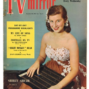 May include: A vintage magazine cover featuring a woman in a white and peach dress playing a zither. The magazine is called "TV Mirror" and the cover features the text "Day-by-Day Programme Highlights", "My Life of Song", "Football on TV", "Right Monkey Read", and "Joan Gilbert every Week".