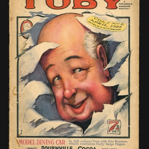 May include: A vintage magazine cover for Toby, a children's magazine, featuring a cartoon illustration of a man's face peeking out from behind torn paper. The magazine cover is dated April 1922 and includes an advertisement for Bournville Cocoa.