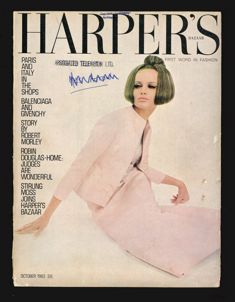 Puede incluir: Una portada de revista para Harper's Bazaar con una mujer vestida con un vestido rosa. El texto de la portada dice: "Harper's Bazaar, First Word in Fashion, Par&iacute;s e Italia en las tiendas, Balenciaga y Givenchy, Historia de Robert Morley, Robin Douglas-Home: Los jueces son maravillosos, Stirling Moss se une a Harper's Bazaar, octubre de 1963, 3/6".