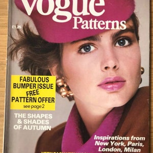 May include: Vogue Patterns magazine cover featuring a woman wearing a pink beret and a brown jacket. The cover text reads "Fabulous Bumper Issue Free Pattern Offer see page 2 The Shapes & Shades of Autumn Inspirations from New York, Paris, London, Milan Very Easy Very Vogue Latest Collectibles Autumn 1985".