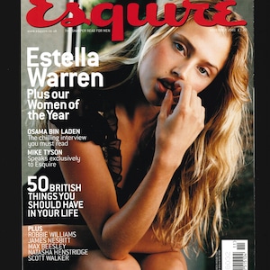 May include: A magazine cover featuring a woman with blonde hair and a black top. The magazine is titled "Esquire" and the cover features the text "Estella Warren" and "Plus our Women of the Year".