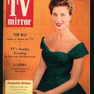 May include: A vintage magazine cover featuring a woman in a green dress. The cover is for TV Mirror, a weekly magazine, and features the text "Ted Ray takes a lesson on TV" and "Garbo A Legend Comes To Your Screen".