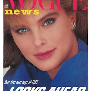 May include: Vogue News magazine cover featuring a woman with blue eyes and short blonde hair wearing a blue shirt. The cover text reads "Your first best buys of 1983 LOOKS AHEAD".