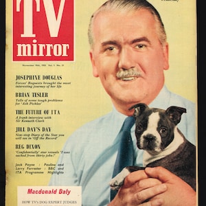 May include: A magazine cover featuring a man holding a Boston Terrier puppy. The magazine is titled "TV Mirror" and the cover story is about Josephine Douglas. The cover also features articles about Brian Tesler, the future of ITA, Jill Day's Day, Reg Dixon, and Macdonald Daly.