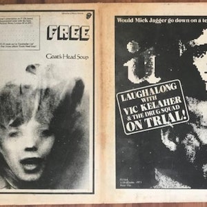 May include: A black and white magazine page with two advertisements. The top ad is for "Free" Goat's Head Soup. The bottom ad is for "Laughalong with Vic Kelahe & The Drug Squad on Trial!"