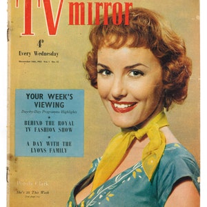 May include: A vintage magazine cover featuring a woman with red hair wearing a blue and white patterned blouse with a yellow scarf. The magazine is called "TV mirror" and the cover text reads "Every Wednesday, November 14th, 1953 Vol. 1 No. 12".