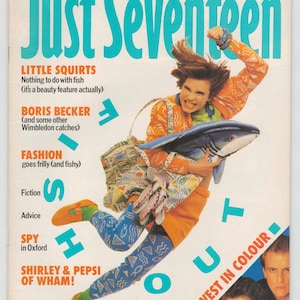 May include: A magazine cover for Just Seventeen, a teen magazine, featuring a young woman wearing a colourful outfit and holding a shark toy. The cover text reads "Go West in Colour!" and features articles about "Little Squirts", "Boris Becker", and "Fashion".