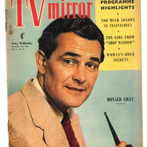 May include: A color magazine cover featuring a man in a tan suit and red tie holding a pipe. The magazine is called "TV Mirror" and the cover text includes "The Week's Programme Highlights", "Too Much London in Television?", "The Girl From "Shop Window"", "Woman's Hour Secrets", and "Donald Gray".
