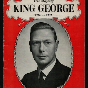 May include: A red cover with a white border and a black and white photo of King George VI. The title reads "His Majesty King George The Sixth" and the text below the photo reads "The Pictorial Life Story of Our Beloved Monarch".